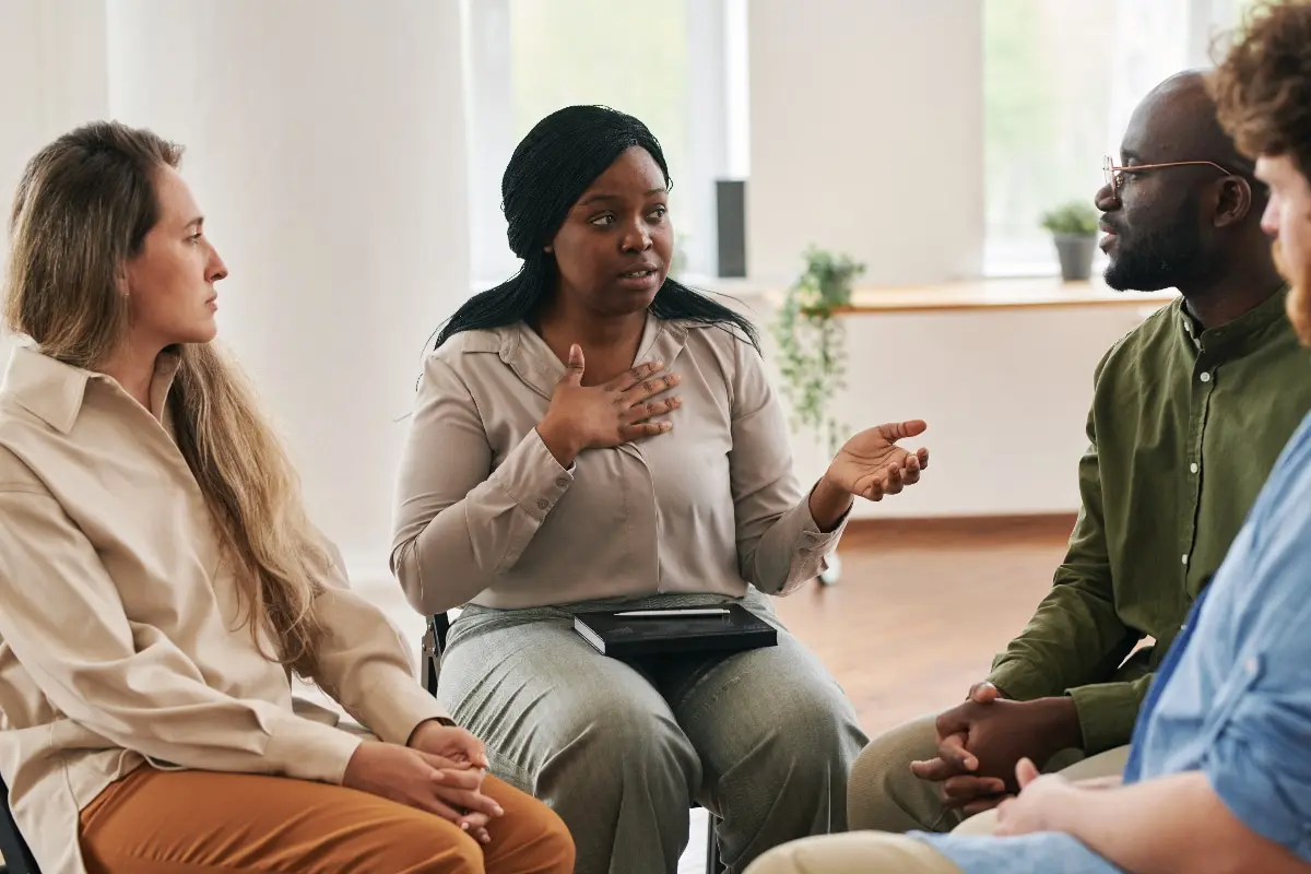 Individuals participating in a family recovery support group, sharing experiences and building healthy communication skills during the healing process.